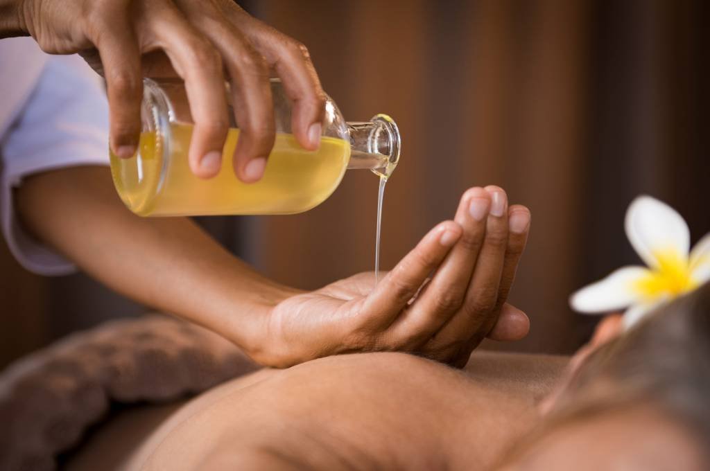 therapist-pouring-massage-oil-spa